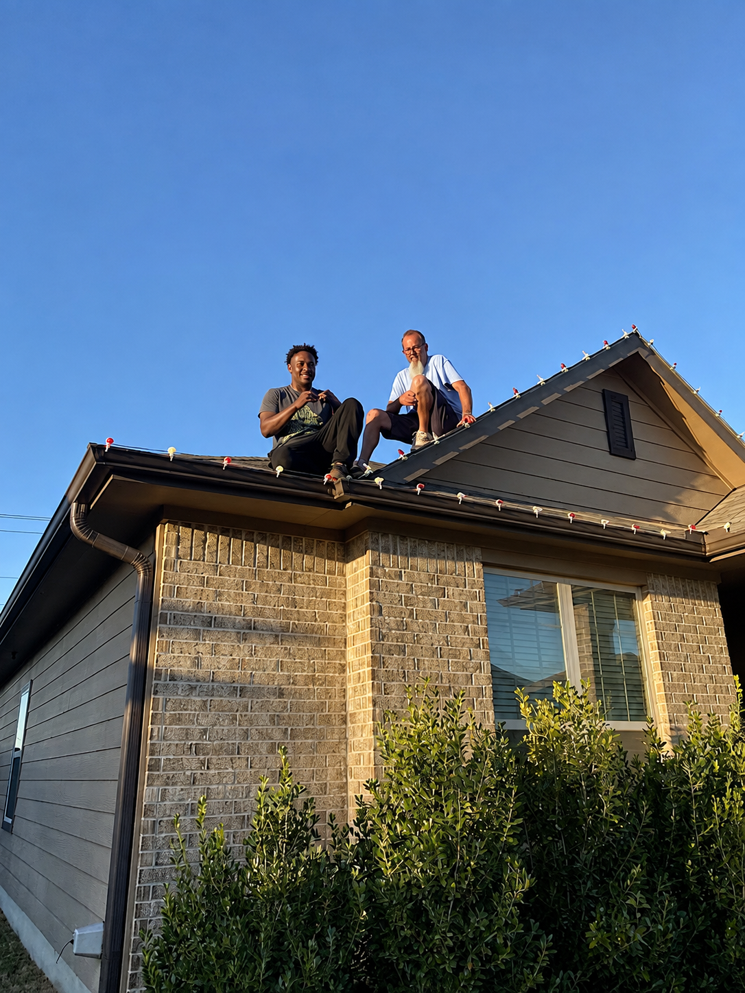 Jason's Holiday Lighting crew installing roofline lights