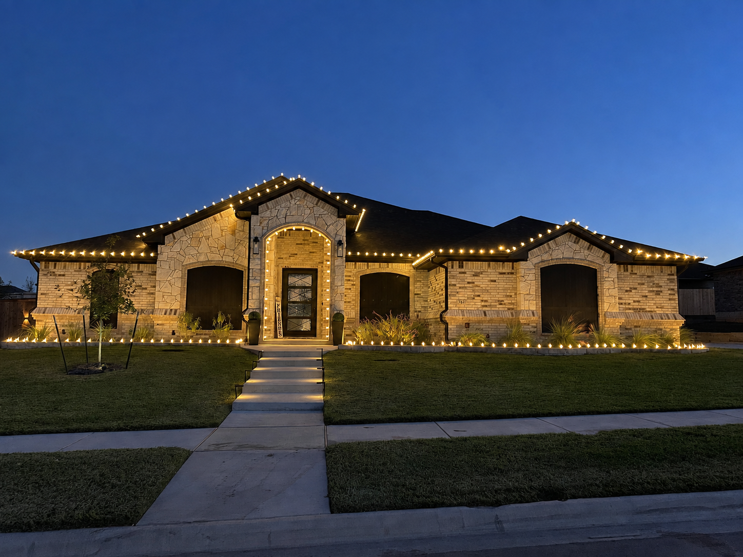 Warm-white holiday lights installed along the roofline only